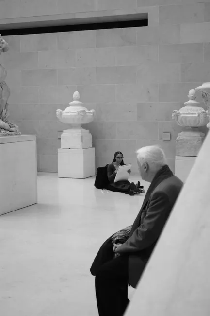 A serene moment with visitors inside the iconic Louvre Museum in Paris.