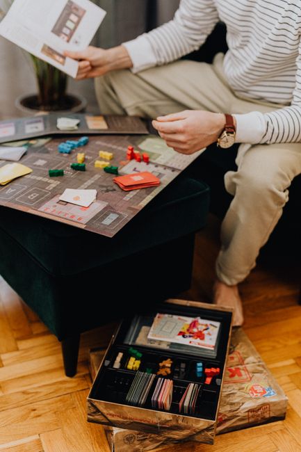 Casual indoor scene of a man enjoying a board game, highlighting leisure and strategy.