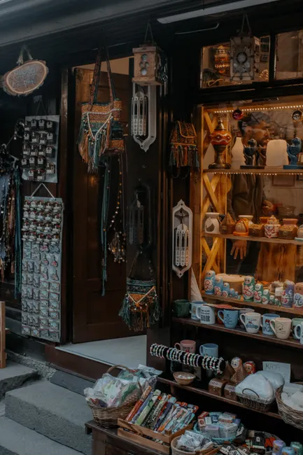 Explore a charming souvenir shop displaying ceramic items and local crafts on a city street.