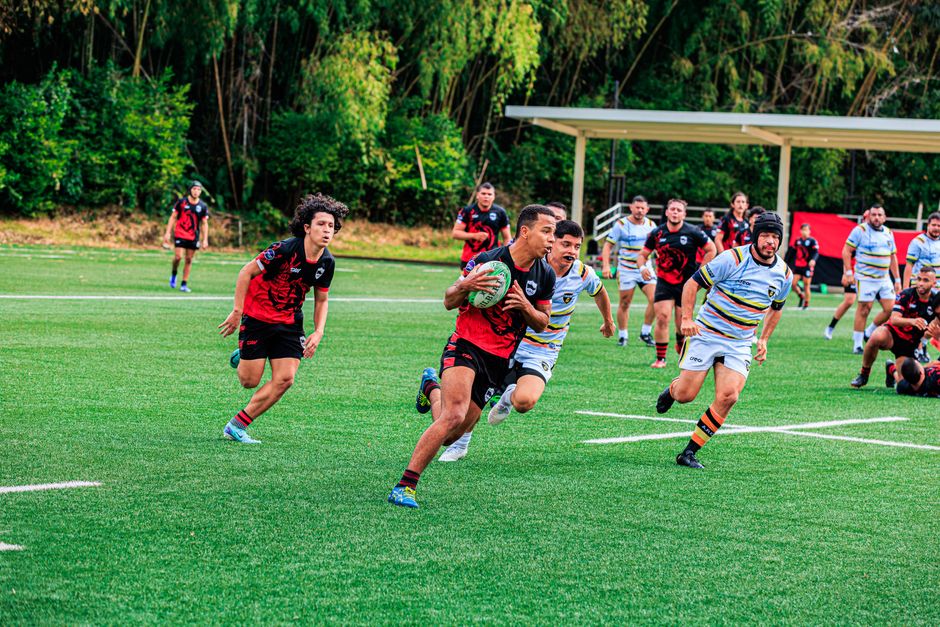 Rugby players competing vigorously on a vibrant green field, showcasing teamwork and athleticism.