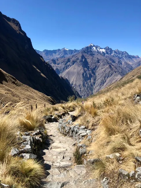 Stunning mountain trail view in the Andes under a clear blue sky, perfect for hiking enthusiasts.